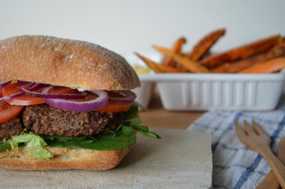 A photo of spicy black bean quinoa hamburger with sweet potato fries. Recipe by That Healthy Kitchen