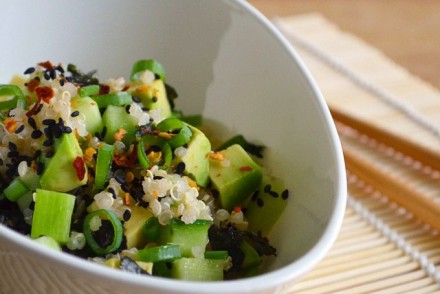 A bowl of sushi salad with quinoa, avocado, spring onion (green onion), black sesame seeds, nori and chili flakes. Photo and recipe by That Healthy Kitchen