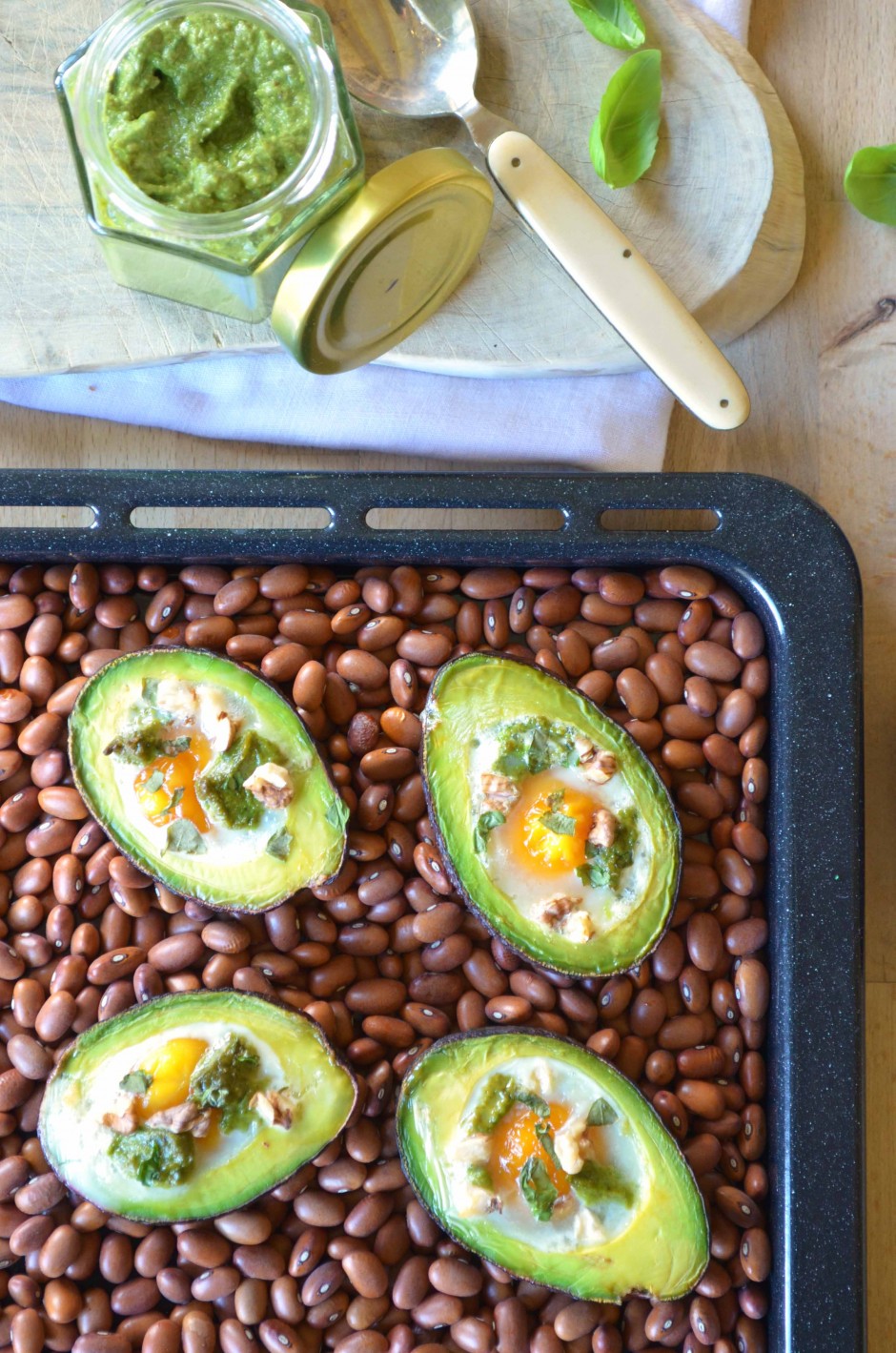 Baked avocado boats with eggs and creamy pesto. Recipe and photo by That Healthy Kitchen